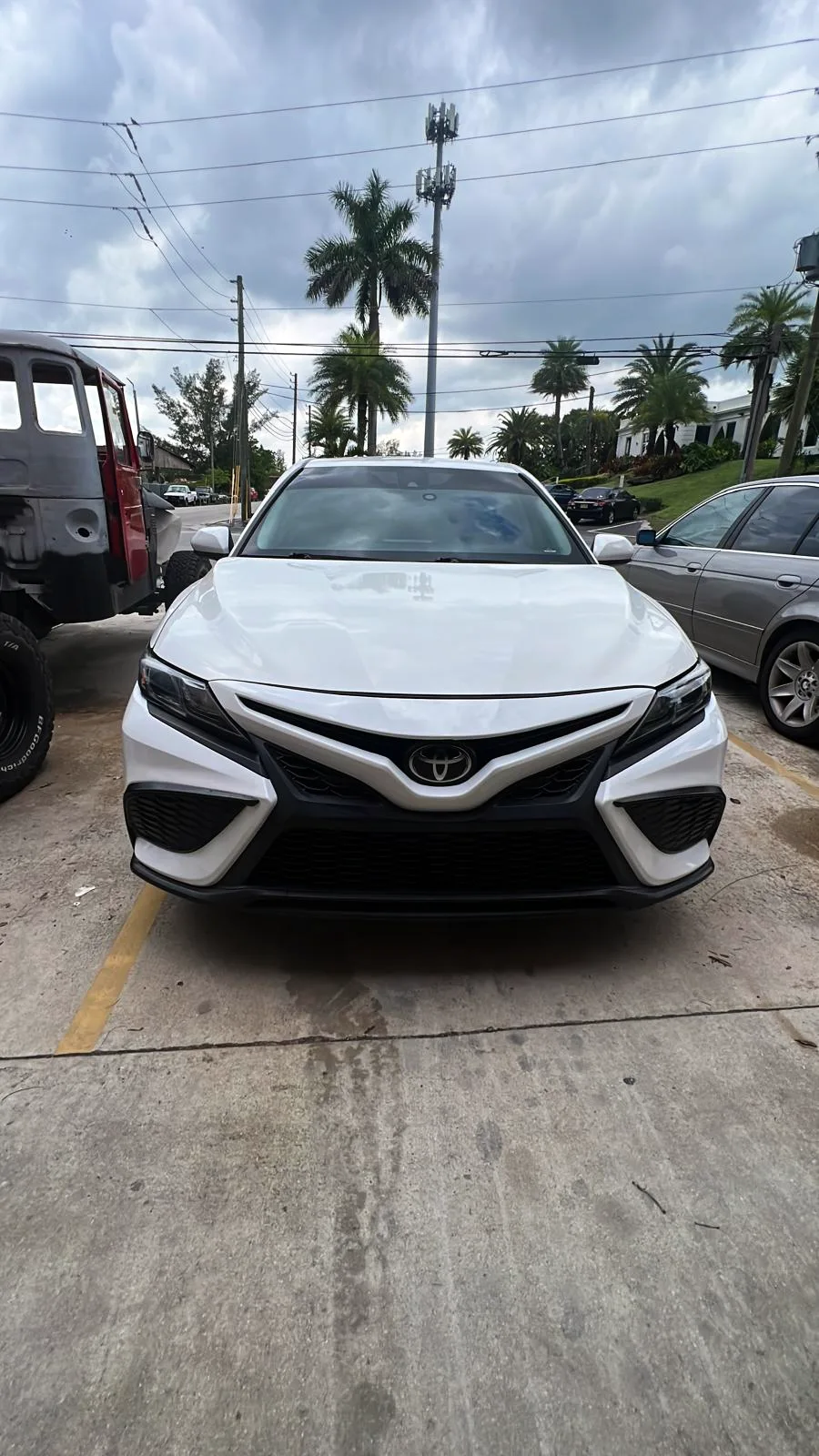 White Toyota Camry finished after bumper repair and paint at the Lake Worth Beach shop