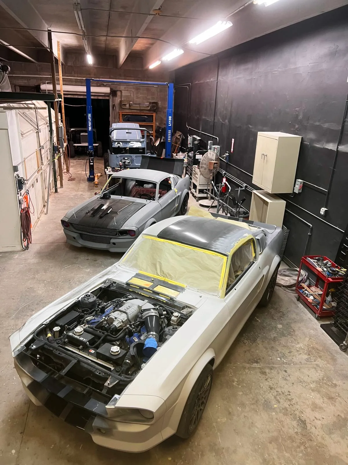 Two classic Mustang restoration projects in the bay at Craft Collision